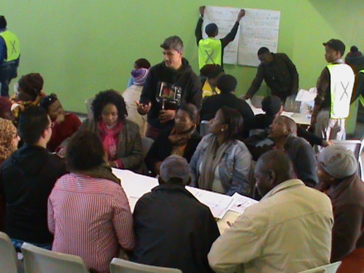 A group being addressed by the facilitator Craig Demont in the Project Management workshop
